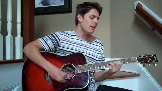 Cole in a striped tee, singing Ocean with his acoustic guitar