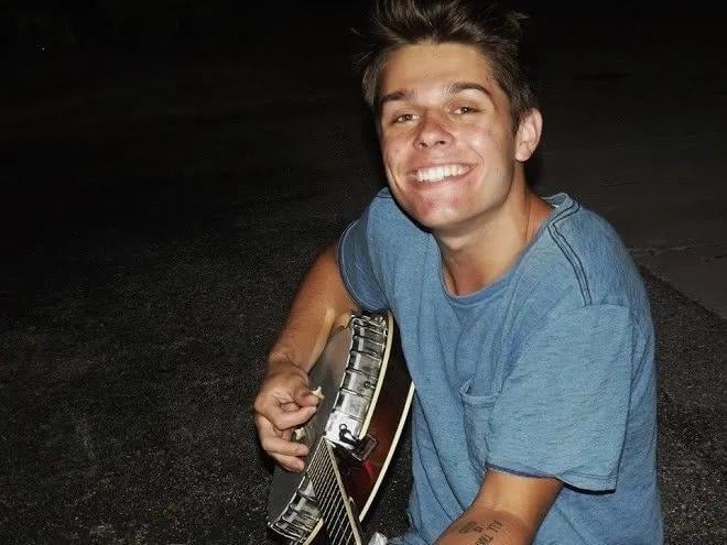 Cole Rassin smiling with his mandolin