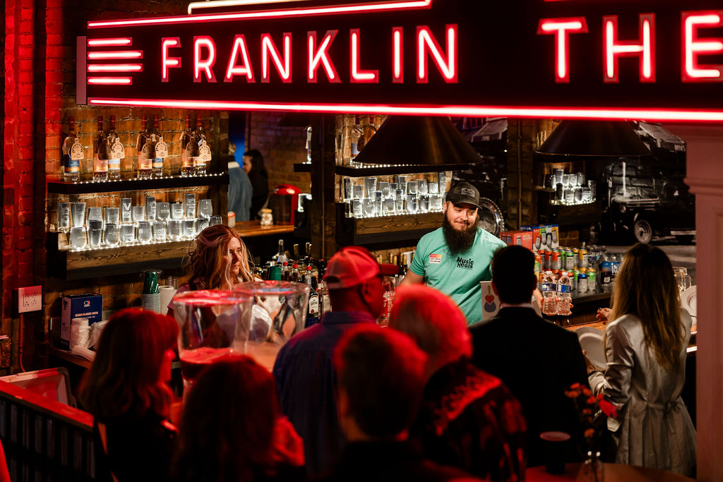 Franklin Theatre bar with volunteer in Music Heals Minds shirt