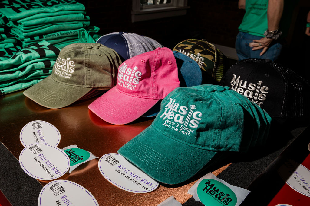 Music Heals Minds hats on a merchandise table